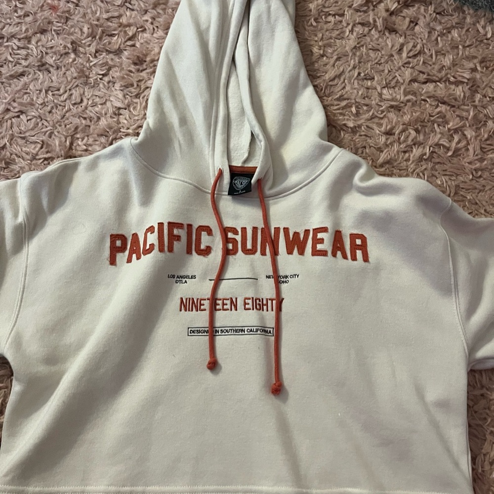 Pacific Sunwear Off-White Hoodie with Red Text